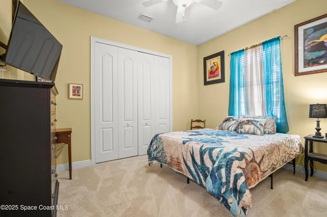 a bedroom with a bed dresser and a window