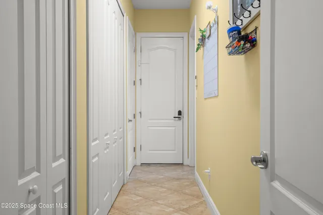 a view of a hallway with wooden floor and closet