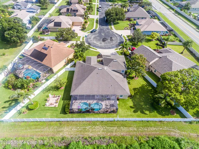 an aerial view of multiple houses with yard