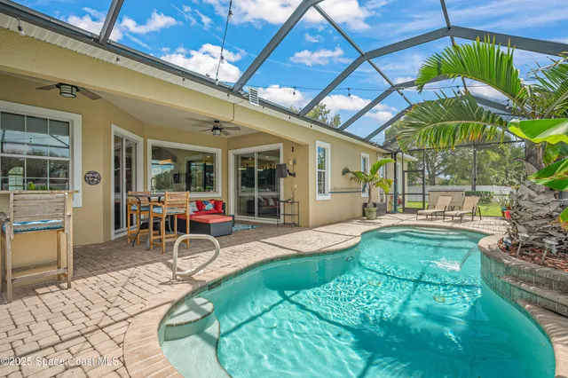 a view of a house with backyard porch and sitting area