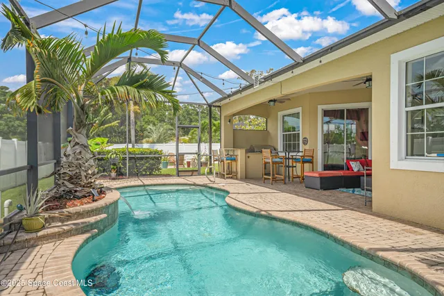 a swimming pool with patio outdoor seating and yard