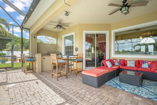 a building outdoor space with patio furniture and potted plants