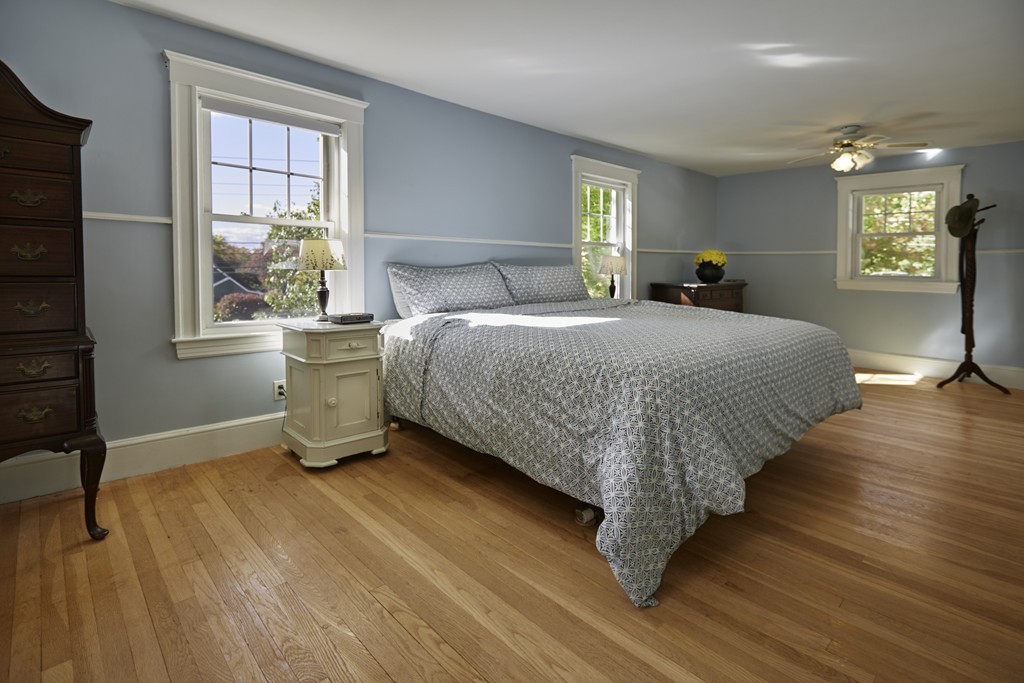 112 Bacon Street Natick, MA 01760 - Photo 14 of 20 a spacious bedroom with a bed and a window
