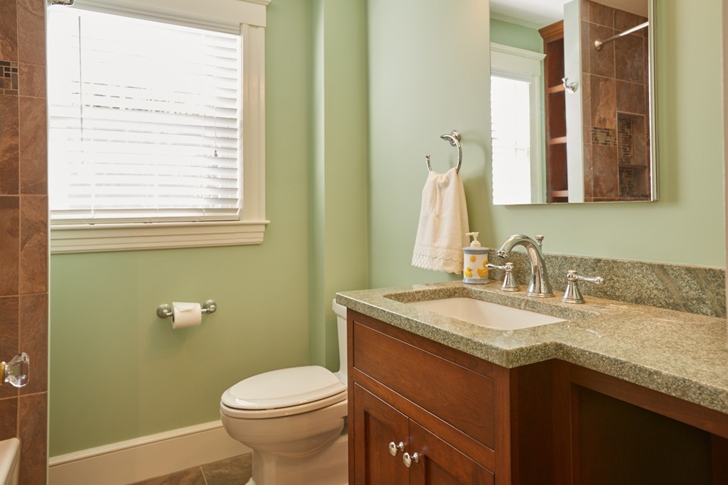112 Bacon Street Natick, MA 01760 - Photo 16 of 20 a bathroom with a granite countertop sink toilet and a mirror
