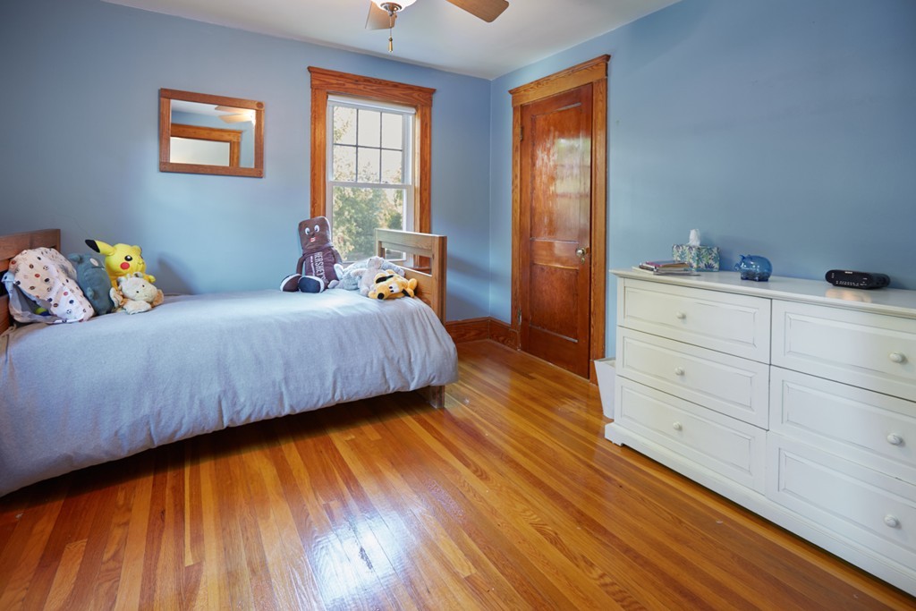 112 Bacon Street Natick, MA 01760 - Photo 17 of 20 a bedroom with a bed and wooden floor