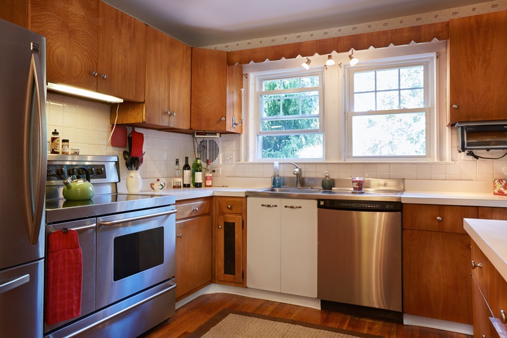 112 Bacon Street Natick, MA 01760 - Photo 3 of 20 a kitchen with stainless steel appliances kitchen island wooden floors and sink