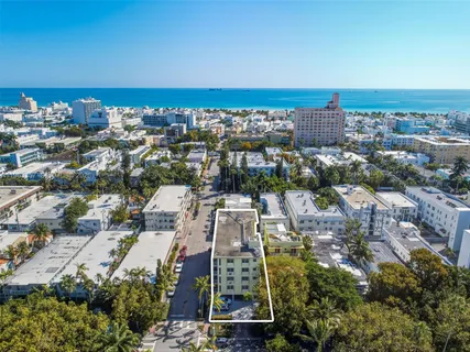 an aerial view of residential building and ocean view