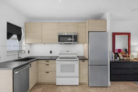 a kitchen with a sink stove and refrigerator