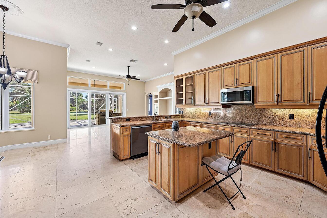 8480 Man O War Road Palm Beach Gardens, FL 33418 - Photo 12 of 45 a kitchen with a stove a sink and a microwave