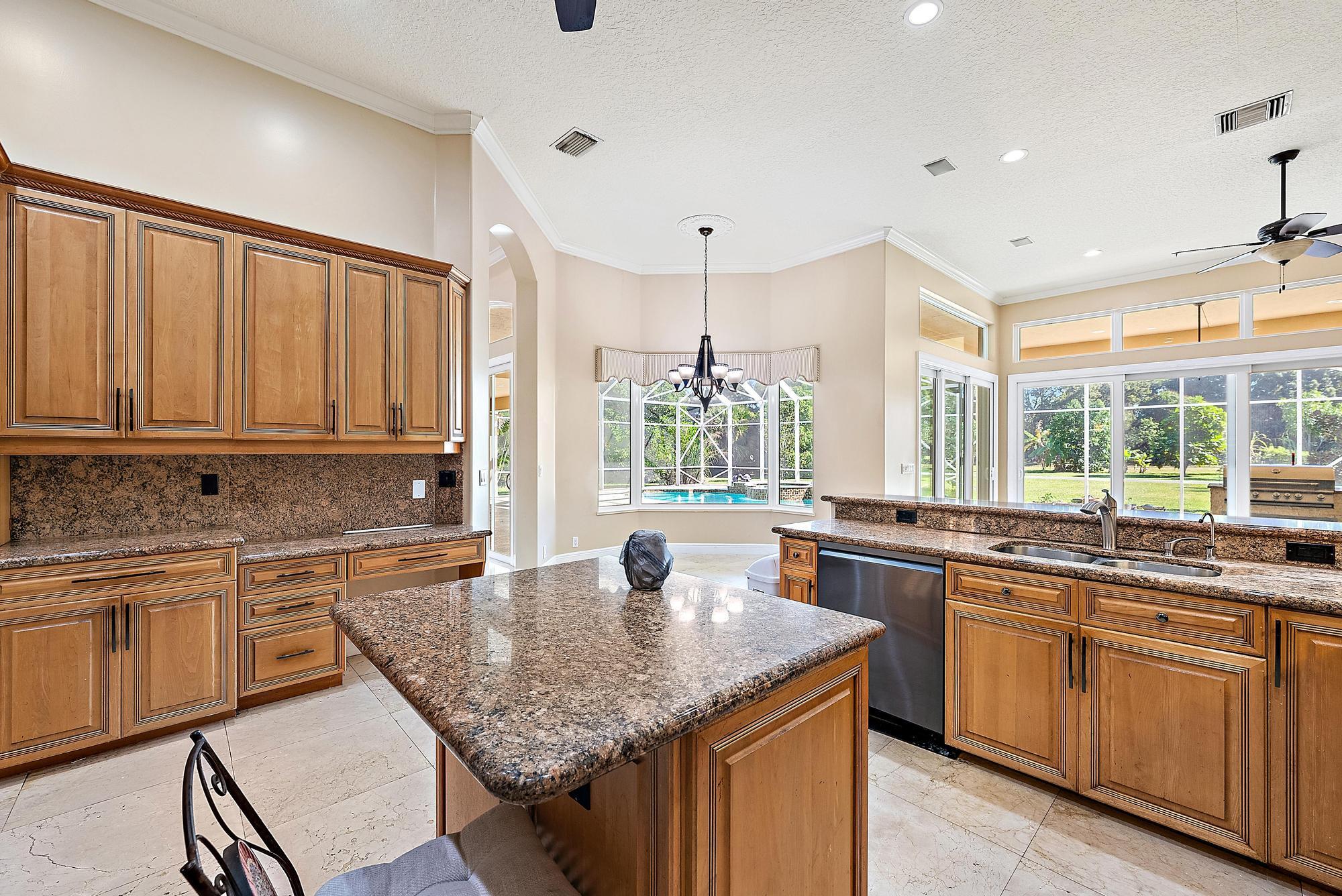 8480 Man O War Road Palm Beach Gardens, FL 33418 - Photo 13 of 45 a kitchen with sink stove and cabinets
