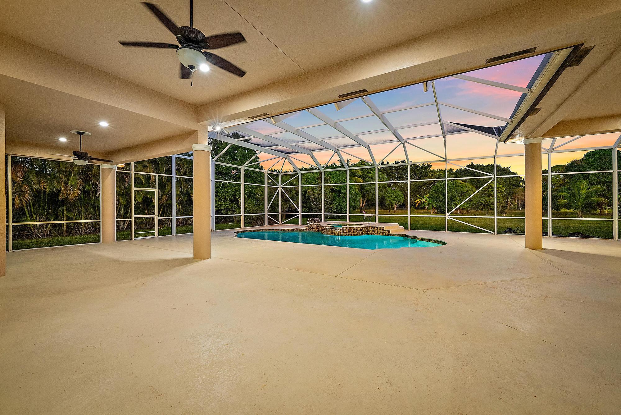 8480 Man O War Road Palm Beach Gardens, FL 33418 - Photo 31 of 45 a view of a room with gym equipment and large windows