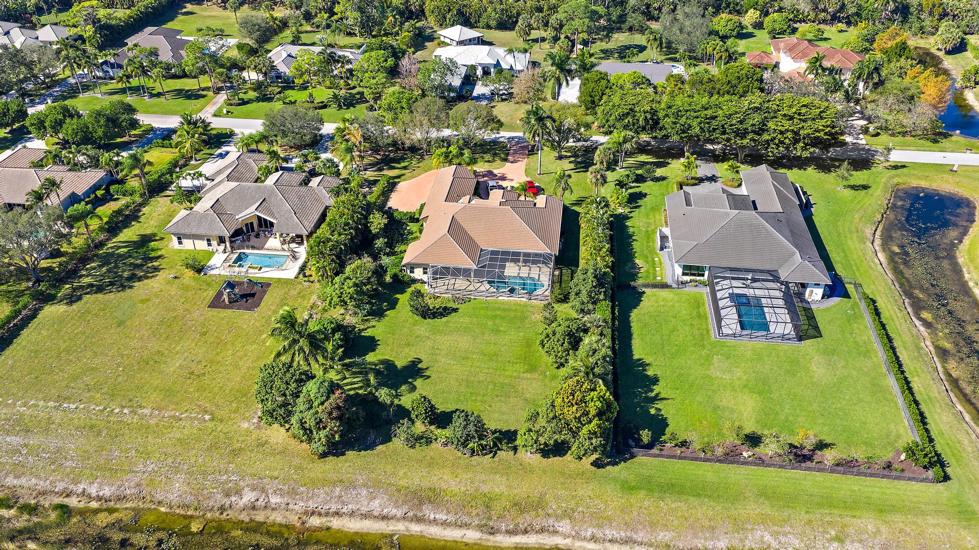 8480 Man O War Road Palm Beach Gardens, FL 33418 - Photo 43 of 45 an aerial view of residential houses with outdoor space and trees