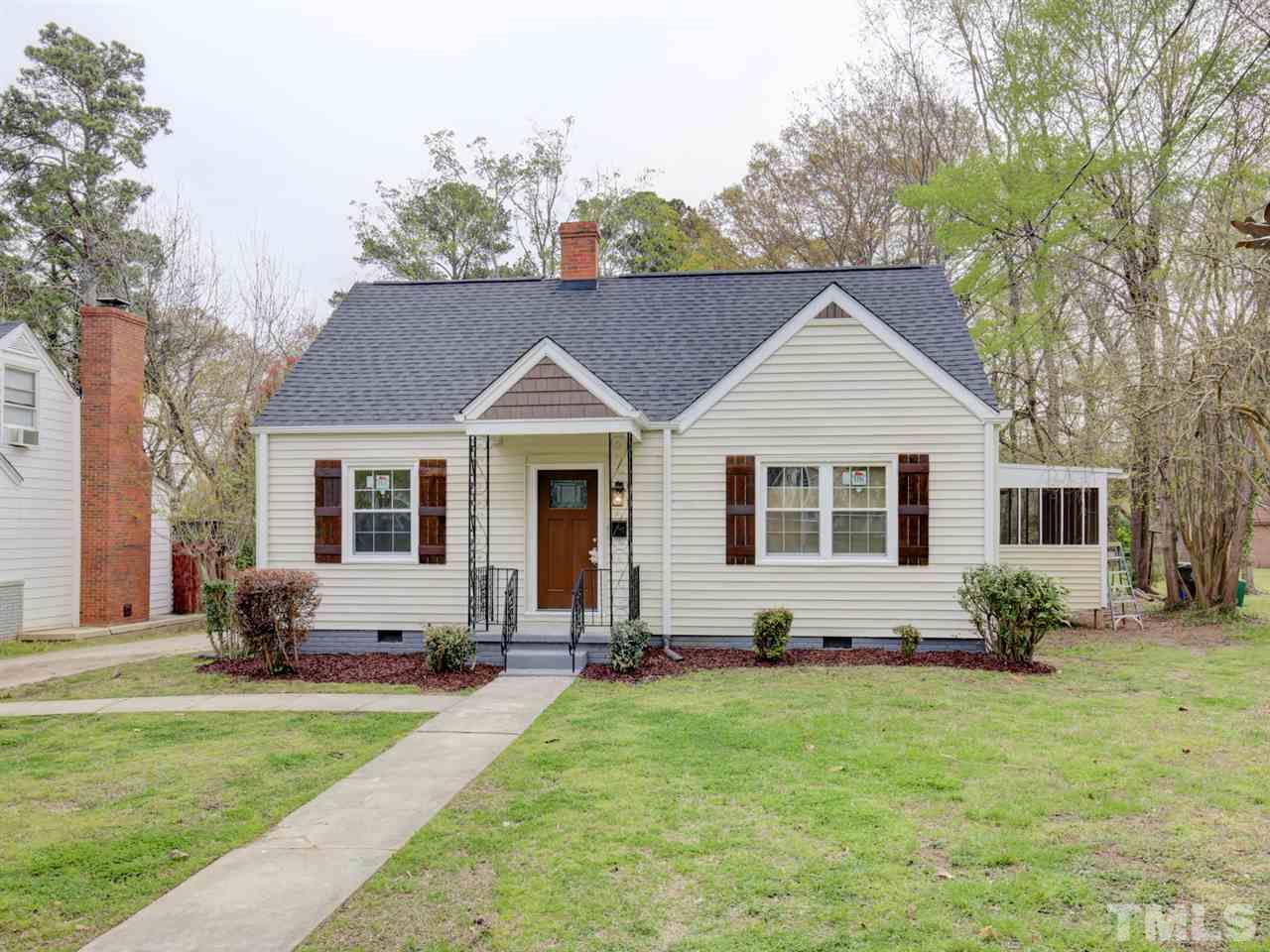 312 Colleton Road Raleigh, NC 27610 - Photo 2 of 25 a view of a yard in front of a house with plants and large tree