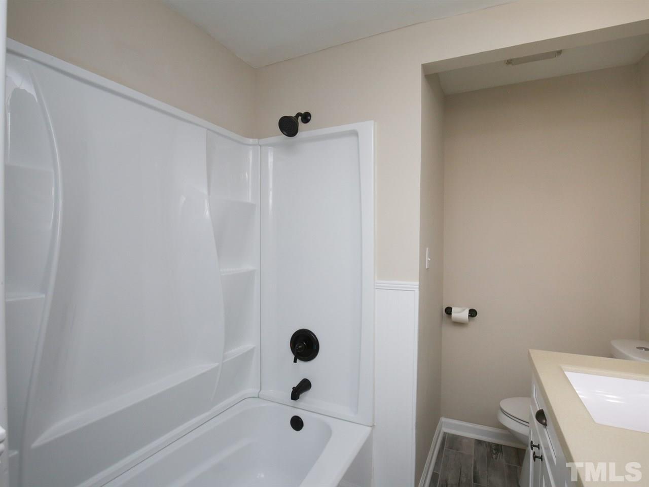 312 Colleton Road Raleigh, NC 27610 - Photo 11 of 25 a bathroom with a bathtub and a toilet