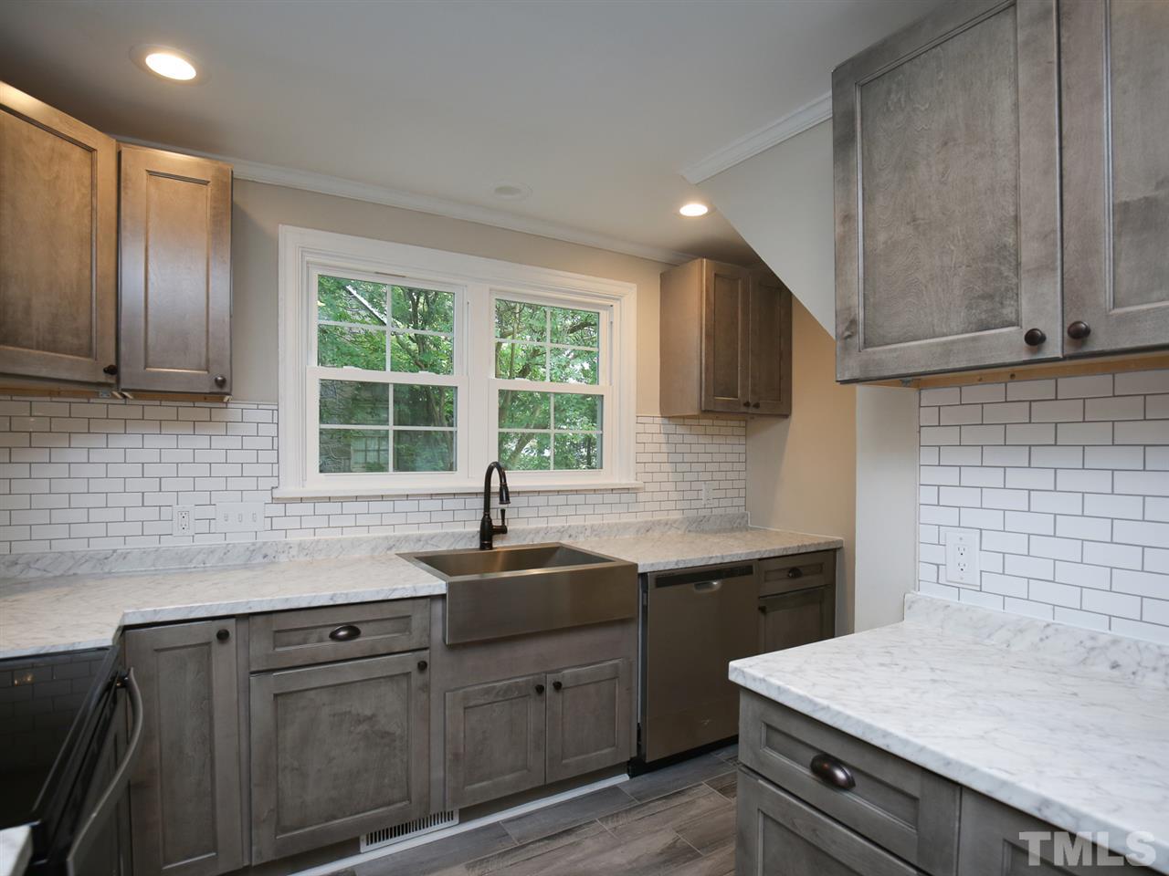 312 Colleton Road Raleigh, NC 27610 - Photo 12 of 25 a kitchen with a sink stove and cabinets