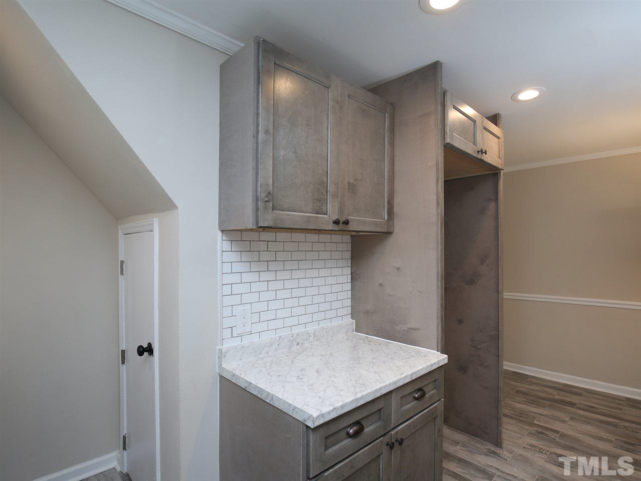 312 Colleton Road Raleigh, NC 27610 - Photo 14 of 25 a kitchen with a sink cabinets and wooden floor