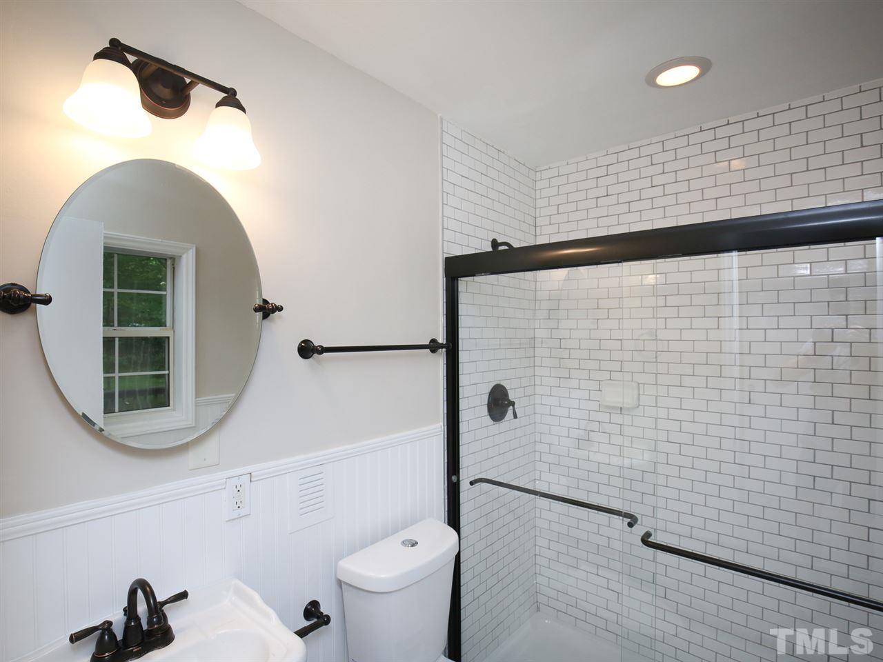 312 Colleton Road Raleigh, NC 27610 - Photo 18 of 25 a bathroom with a toilet and a shower