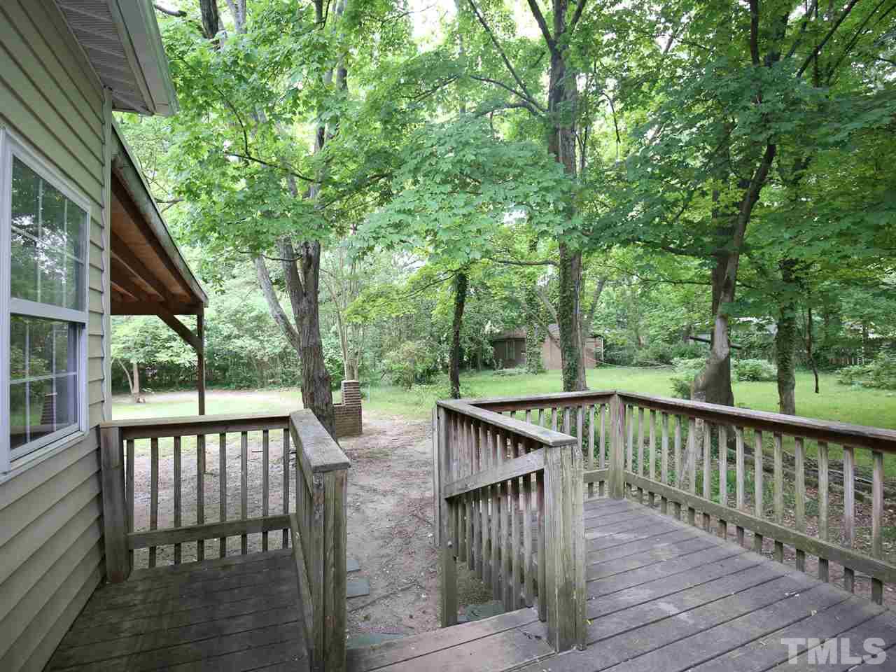 312 Colleton Road Raleigh, NC 27610 - Photo 22 of 25 a view of a wooden deck and a yard with wooden fence