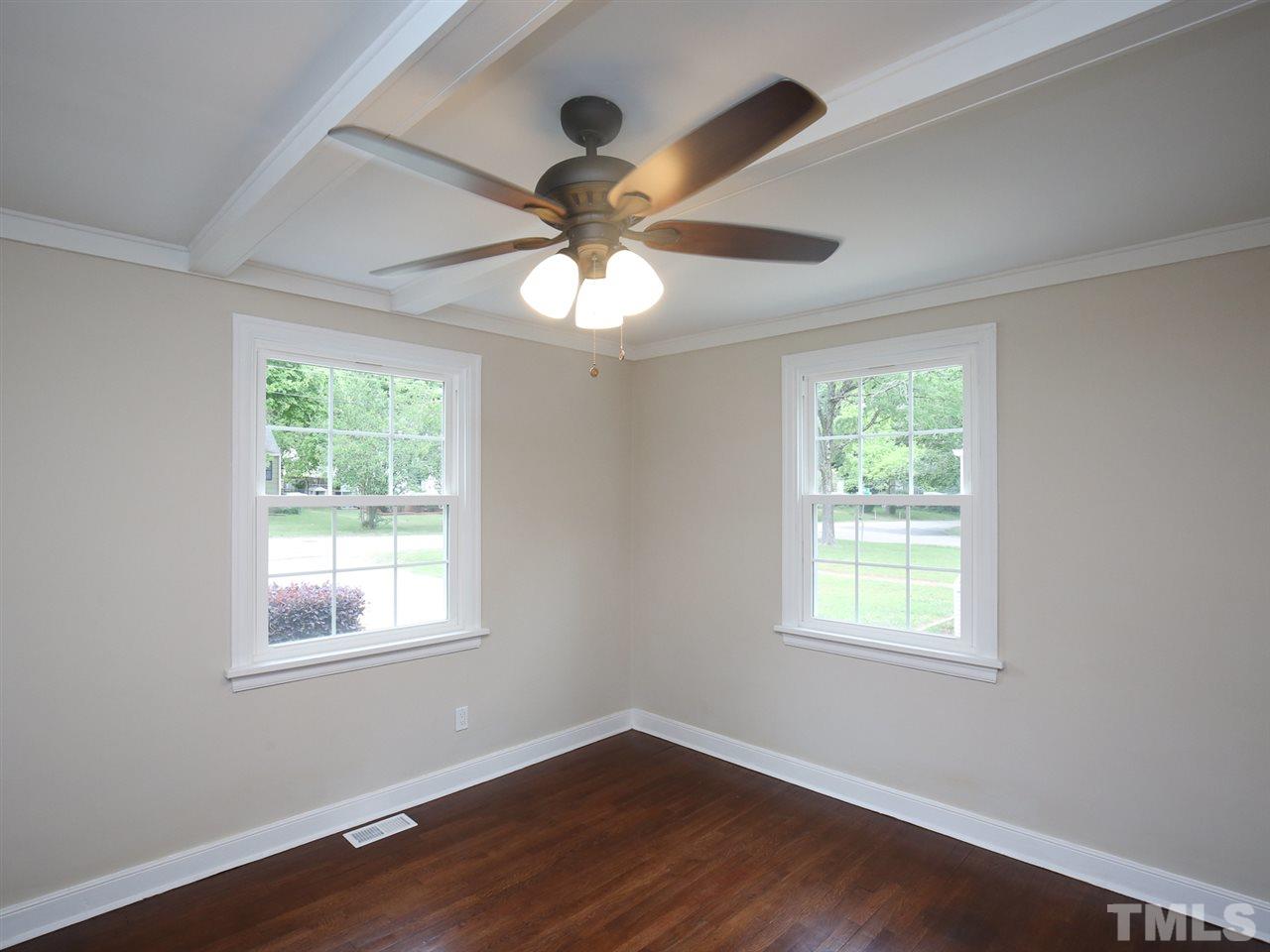 312 Colleton Road Raleigh, NC 27610 - Photo 7 of 25 a view of an empty room with wooden floor and a window