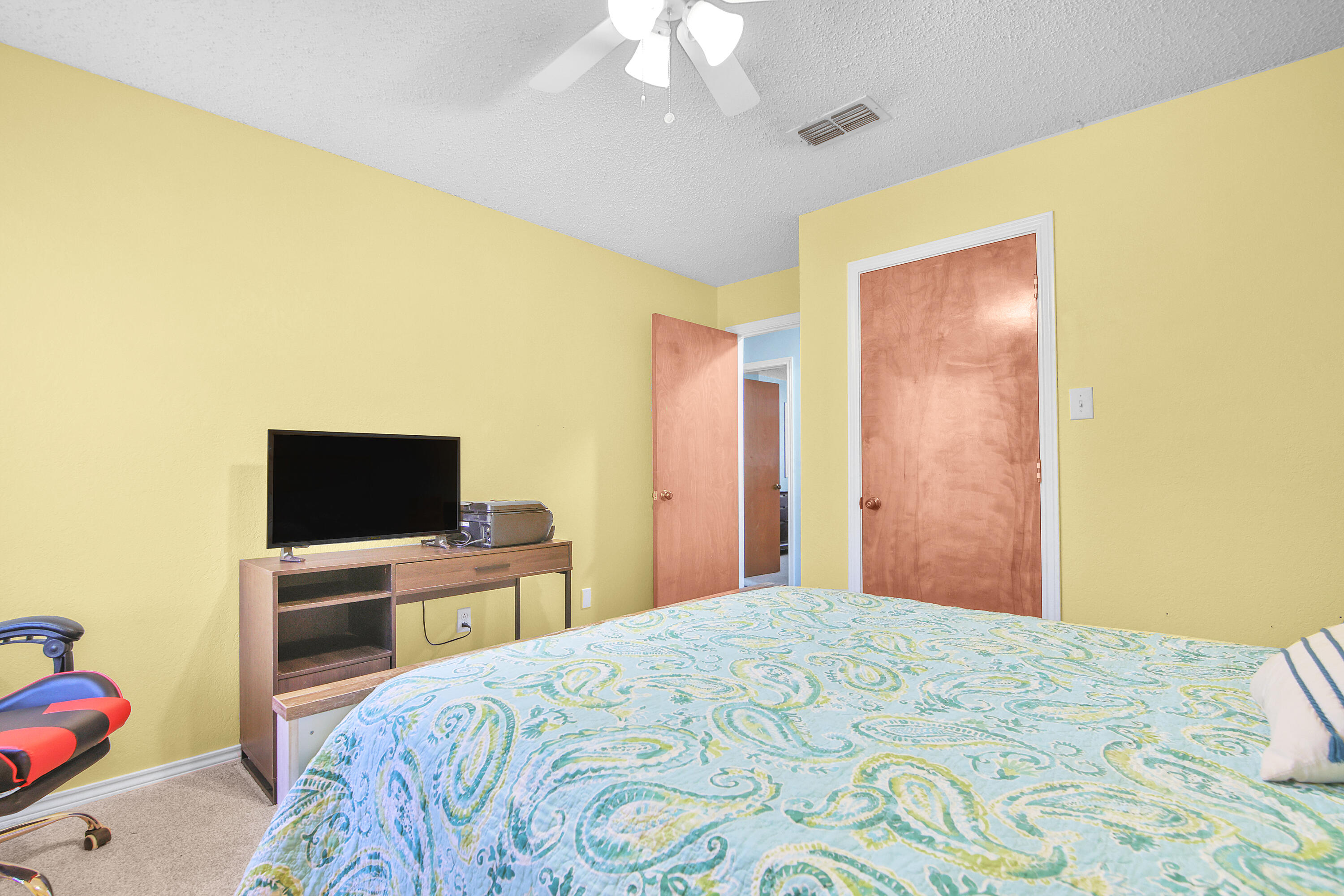 4805 73rd Street Lubbock, TX 79424 - Photo 19 of 26 a bedroom with a bed and a flat screen tv