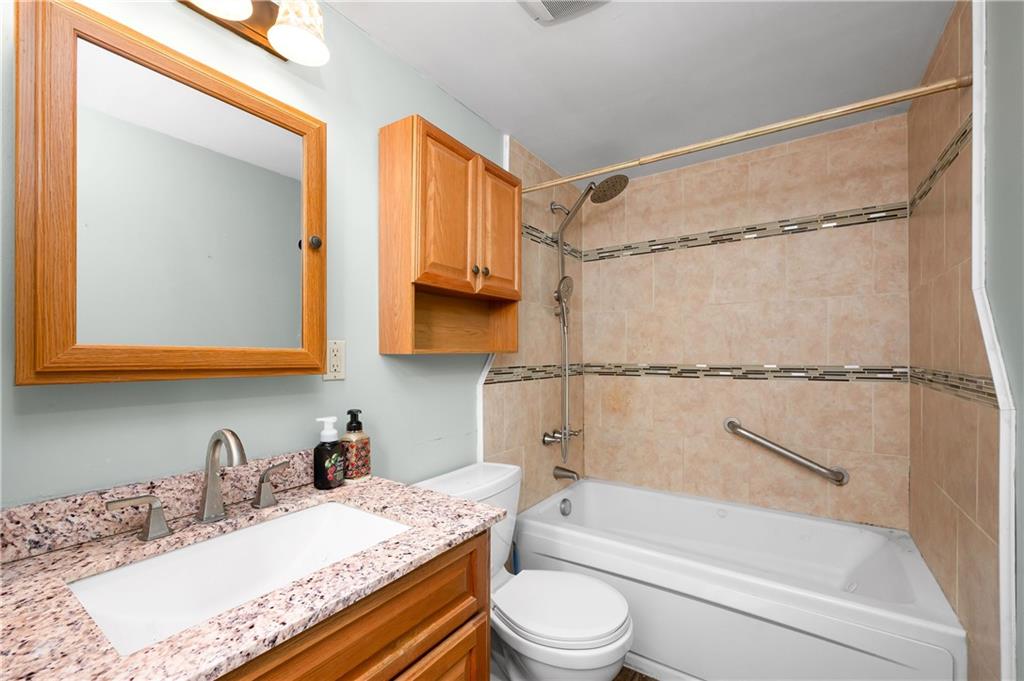 201 Colleen Street Butler, PA 16001 - Photo 21 of 33 a bathroom with a granite countertop sink mirror toilet and bathtub