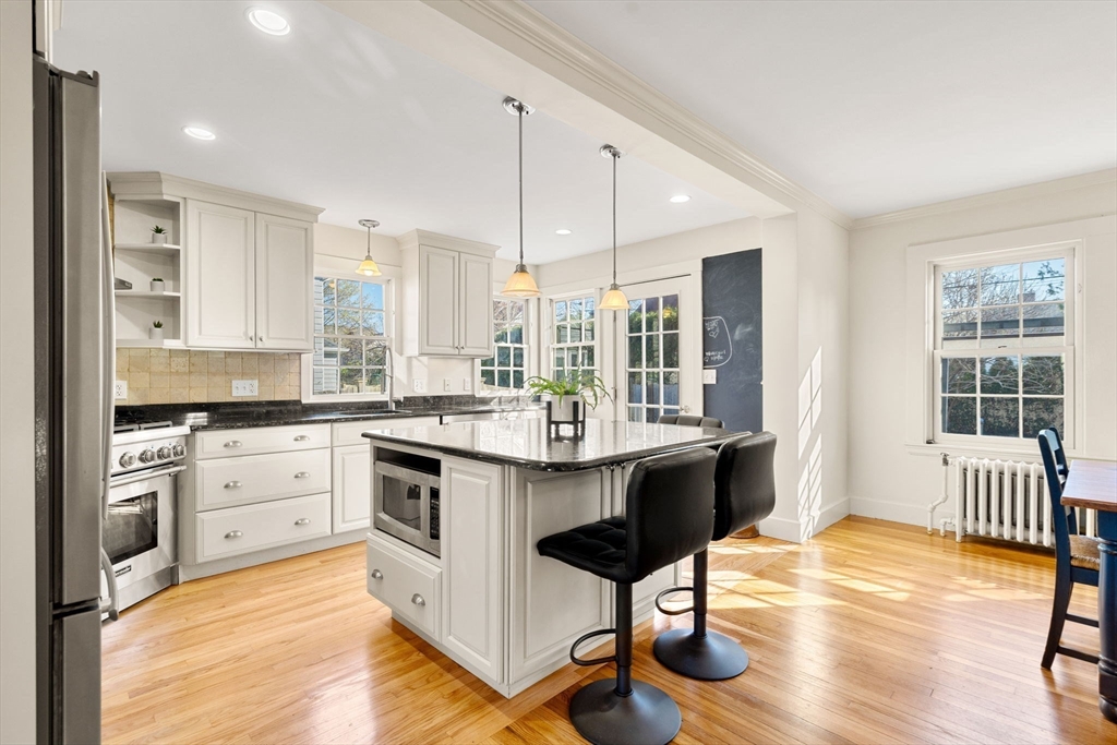 10 Pickwick Road Marblehead, MA 01945 - Photo 5 of 42 a kitchen with stainless steel appliances granite countertop a stove a sink dishwasher and a stove with wooden floor