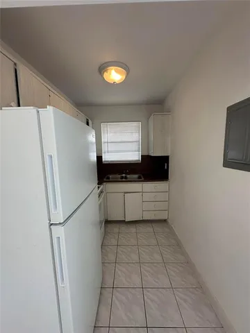 a kitchen with a refrigerator and a stove
