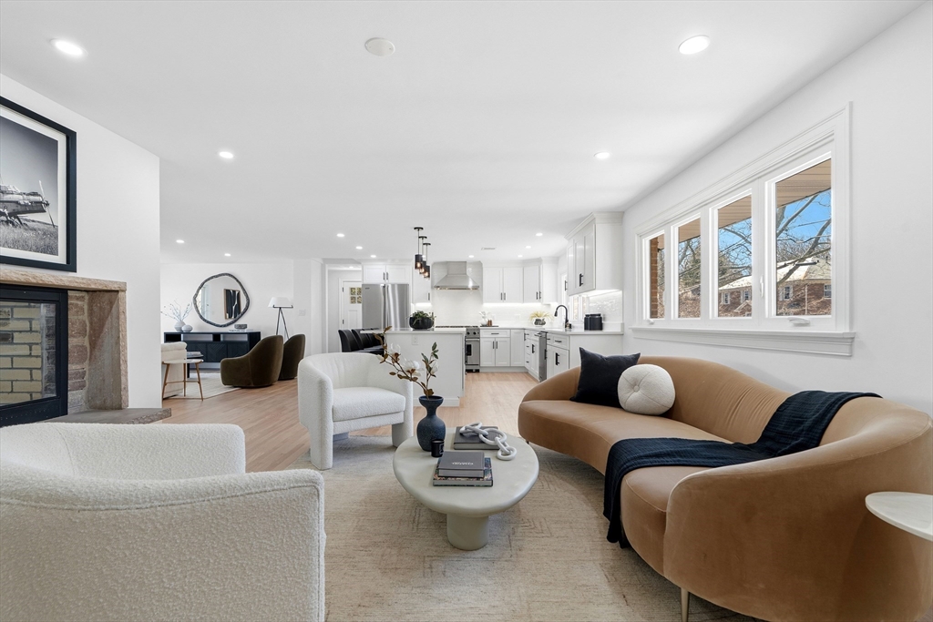 171 Shaw Road Brookline, MA 02467 - Photo 2 of 42 a living room with furniture and a fireplace