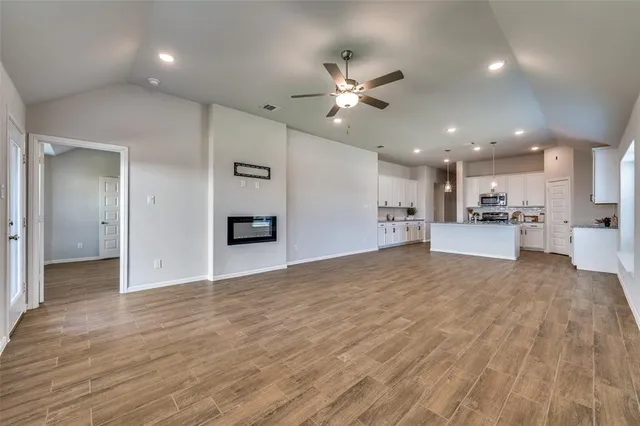 a view of a kitchen with a sink and a refrigerator