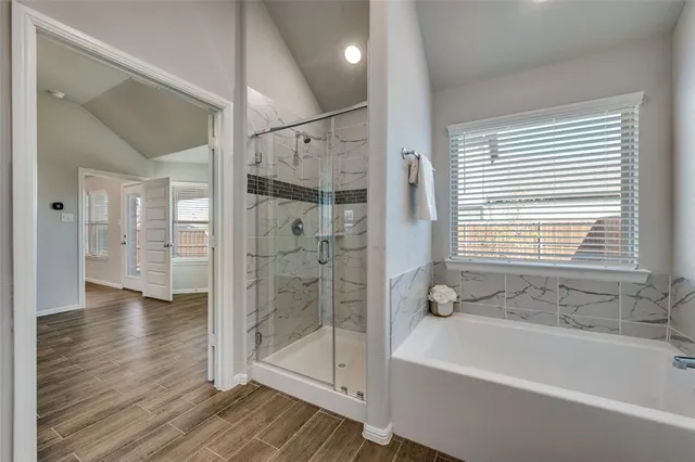 a bathroom with a bathtub and a shower