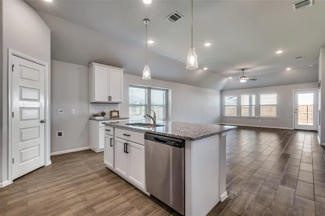 a kitchen with stainless steel appliances granite countertop a stove and a sink