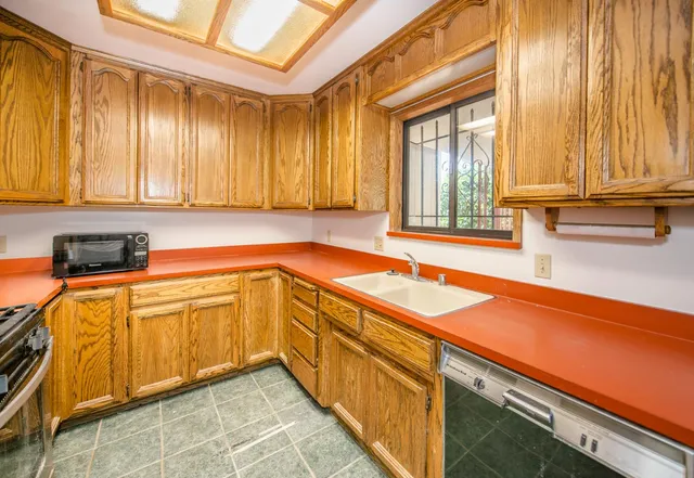 a kitchen with a sink and cabinets