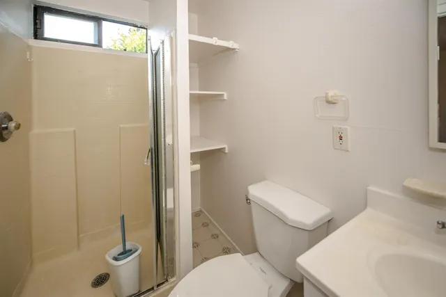 a white toilet sitting next to a bathroom sink