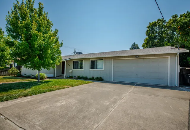 a view of a house with a yard and garage