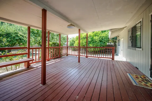 a view of a balcony with wooden floor
