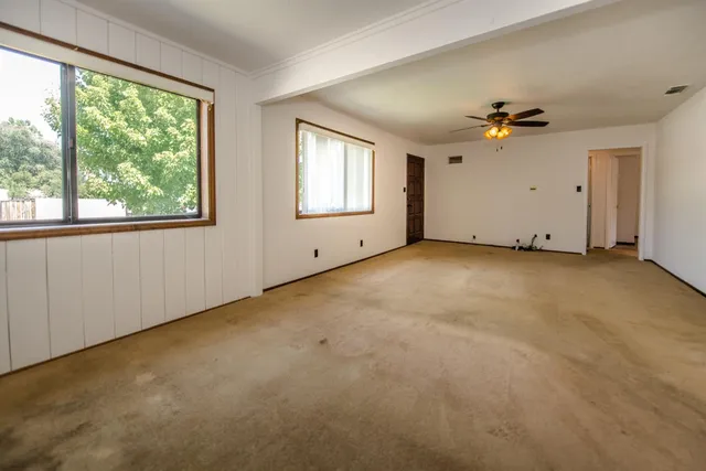 an empty room with windows and closet