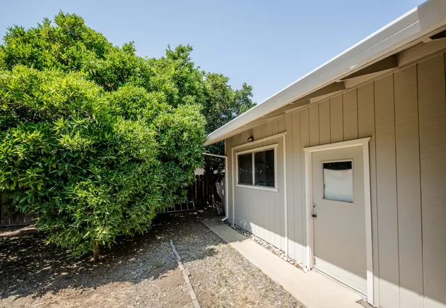 a front view of a house with trees
