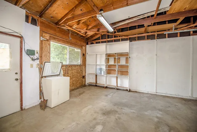 a view of an empty room with white walls