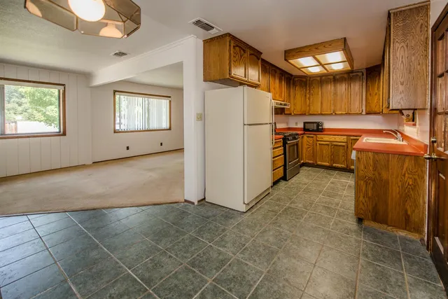 a kitchen with a refrigerator and a sink