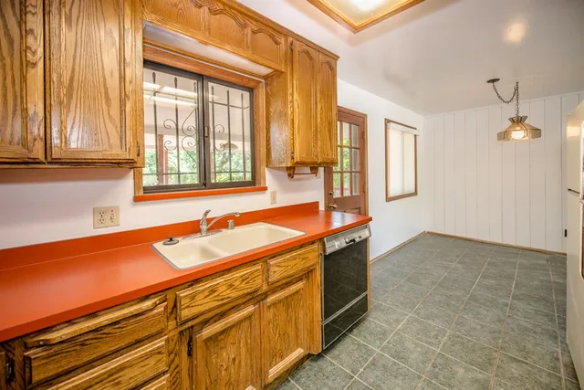 a spacious bathroom with a granite countertop sink and a bathtub