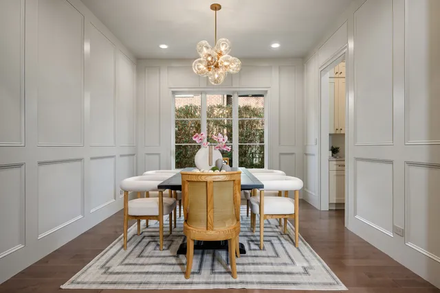 a kitchen with granite countertop a sink stainless steel appliances and white cabinets