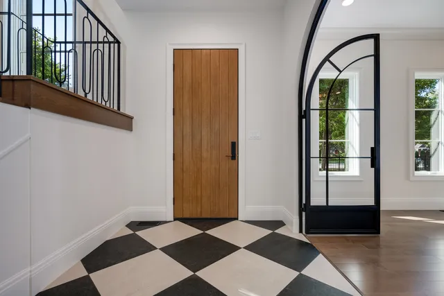 a view of a dining room with furniture a potted plant and wooden floor