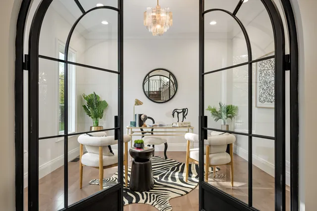 a view of a dining room with furniture wooden floor and chandelier