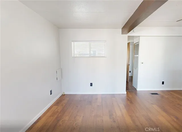 an empty room with wooden floor