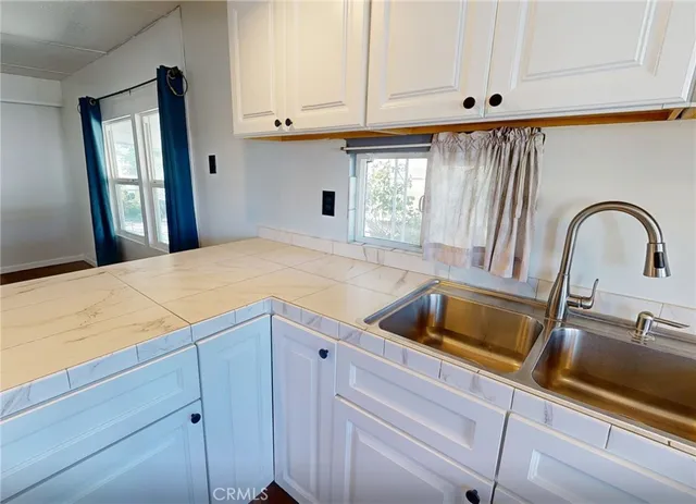 a kitchen with a sink and cabinets