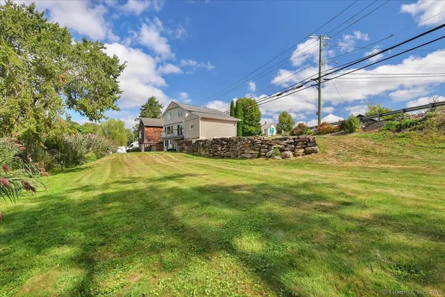 a view of a fountain in front of the house
