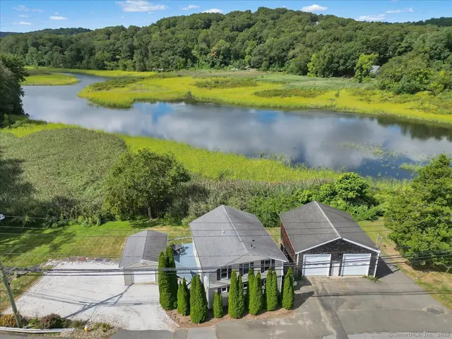 a view of a swimming pool with a yard and a lake view