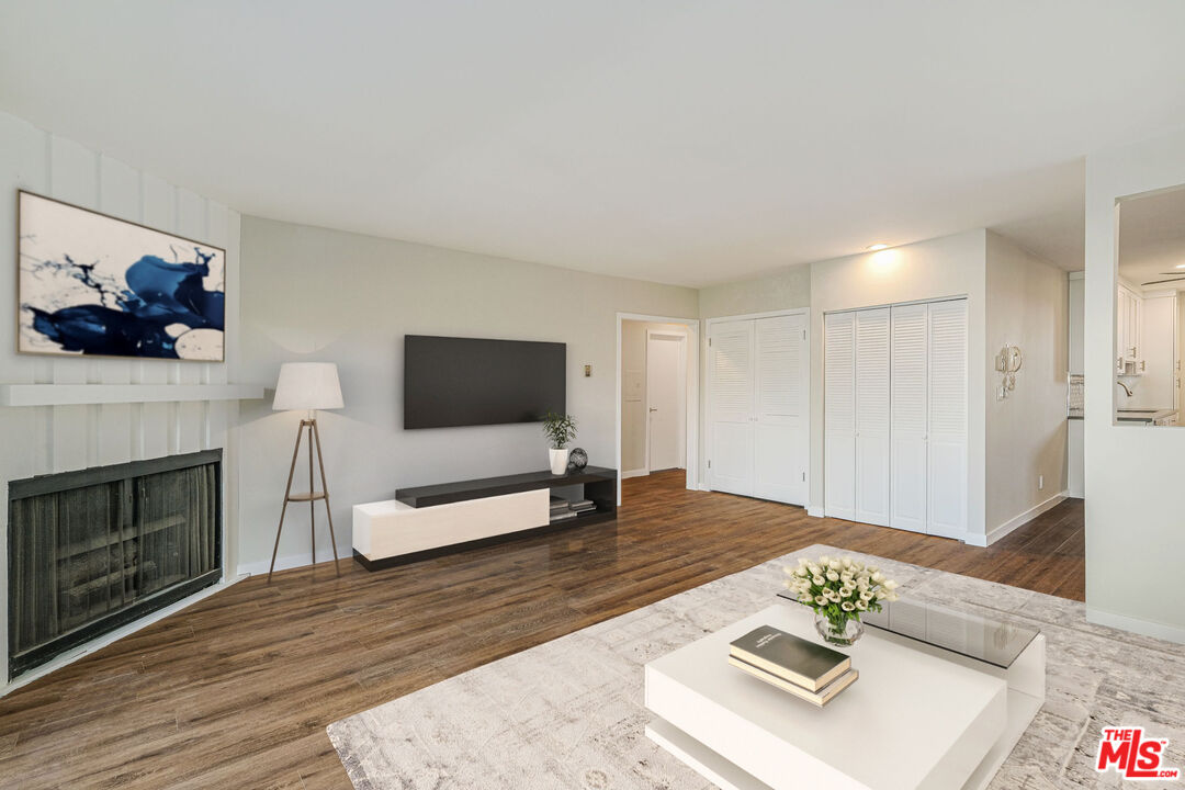1342 Harvard Street, Unit 201 Santa Monica, CA 90404 - Photo 1 of 15 a living room with furniture and a fireplace
