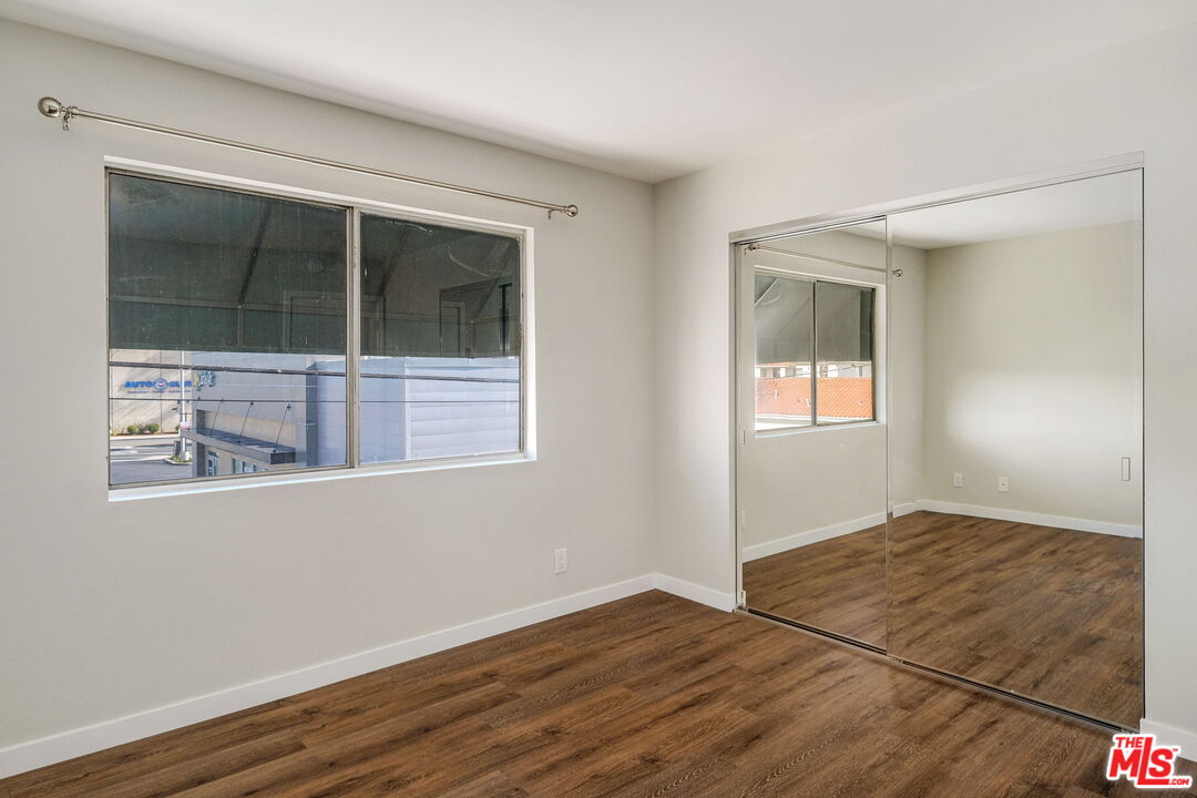 1342 Harvard Street, Unit 201 Santa Monica, CA 90404 - Photo 12 of 15 an empty room with wooden floor and windows