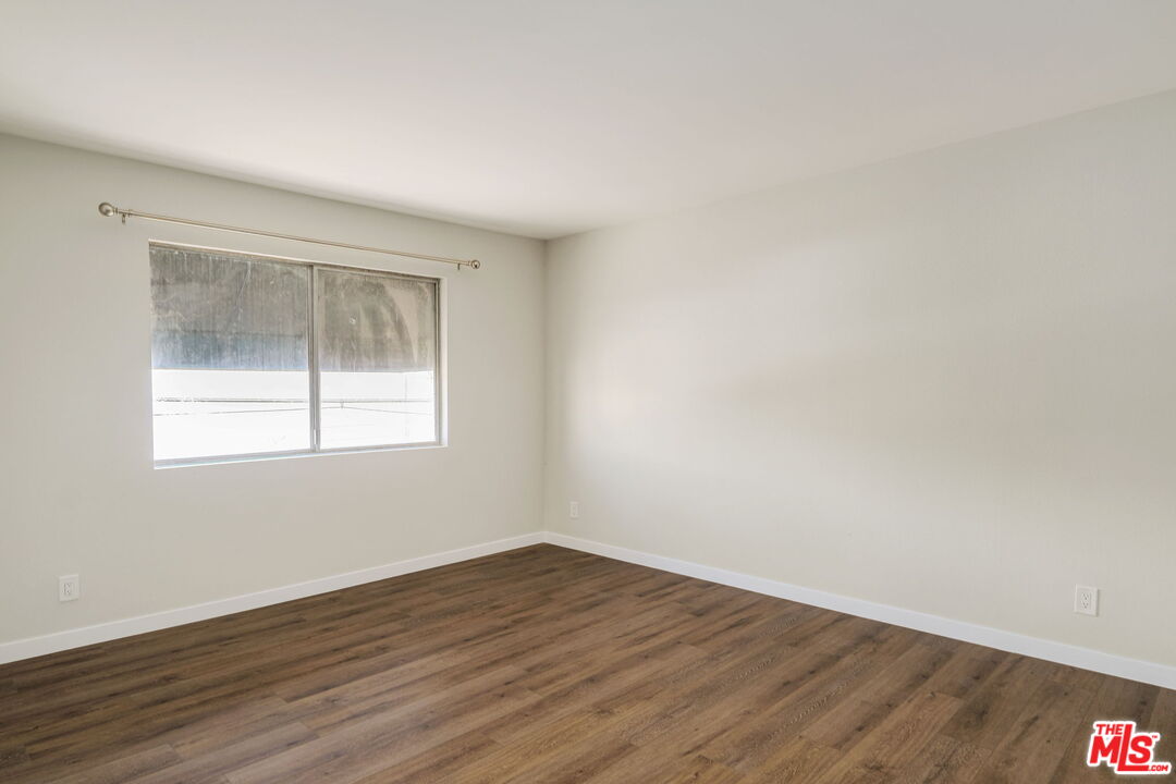 1342 Harvard Street, Unit 201 Santa Monica, CA 90404 - Photo 14 of 15 a view of an empty room with wooden floor and a window
